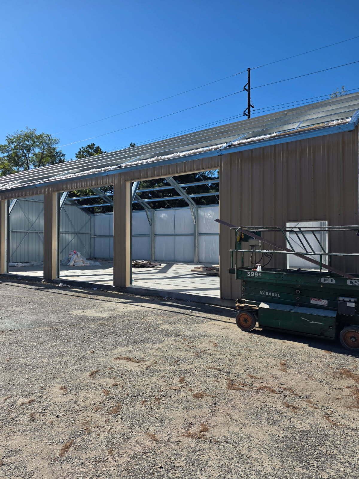 Open bays and installed roof panels on a steel building